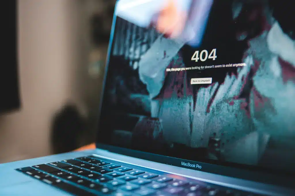Photo of a 404 error on a MacBook Pro screen depicting a fake computer virus