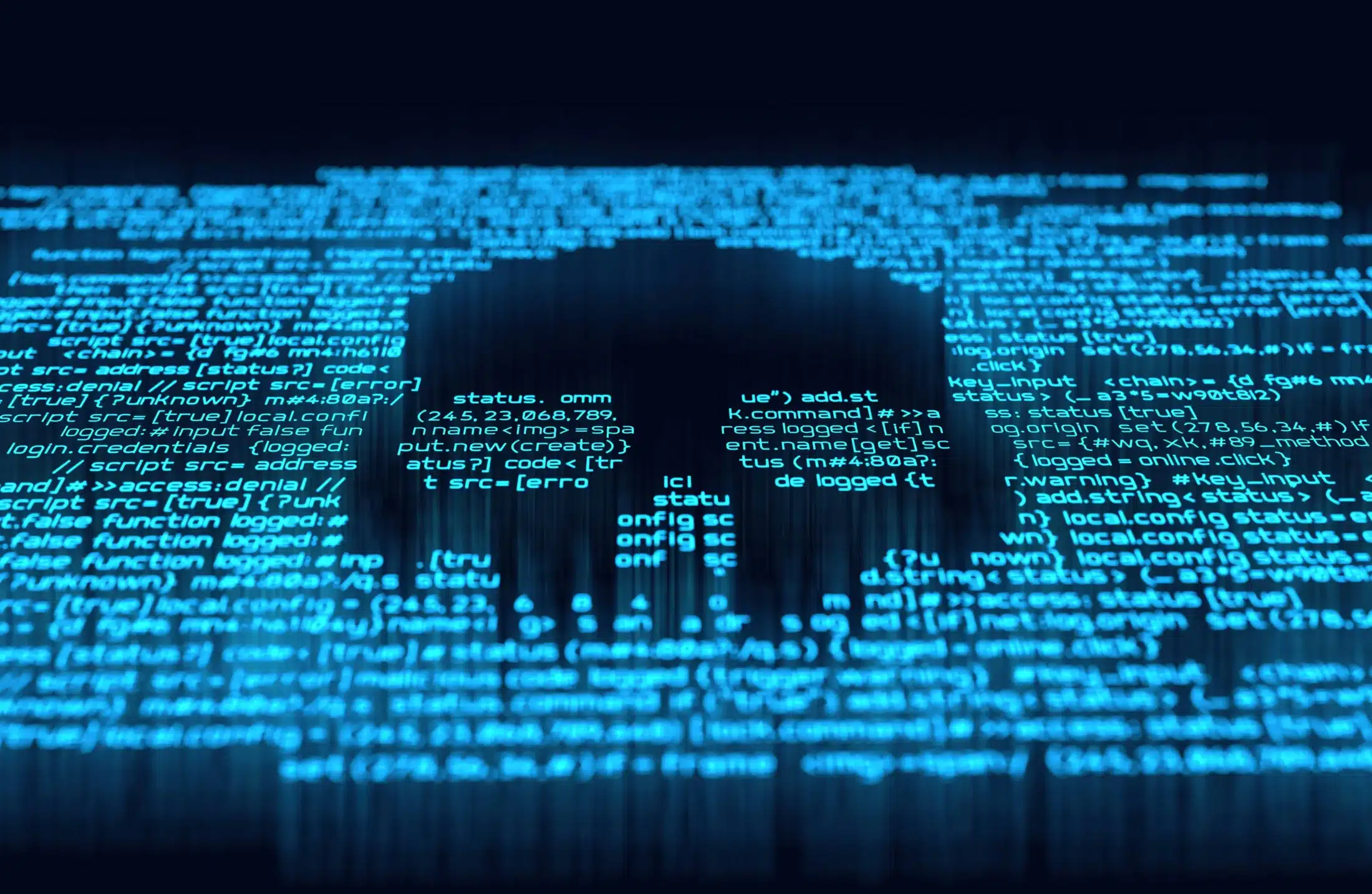 Photo of a computer screen with blue code shaped into a skull depicting computer virus vs malware