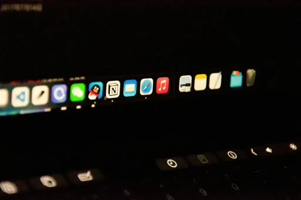 Photo of a MacBook screen showing app icons