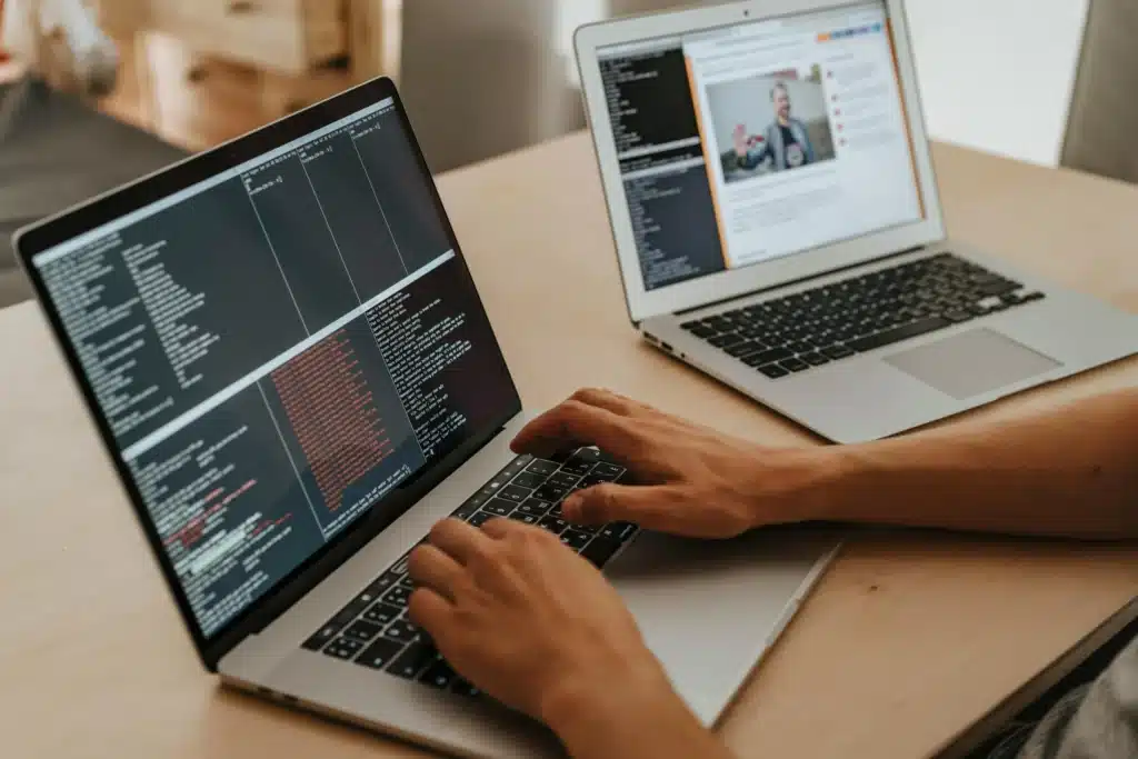 Photo of two laptops displaying codes for cyber technicians
