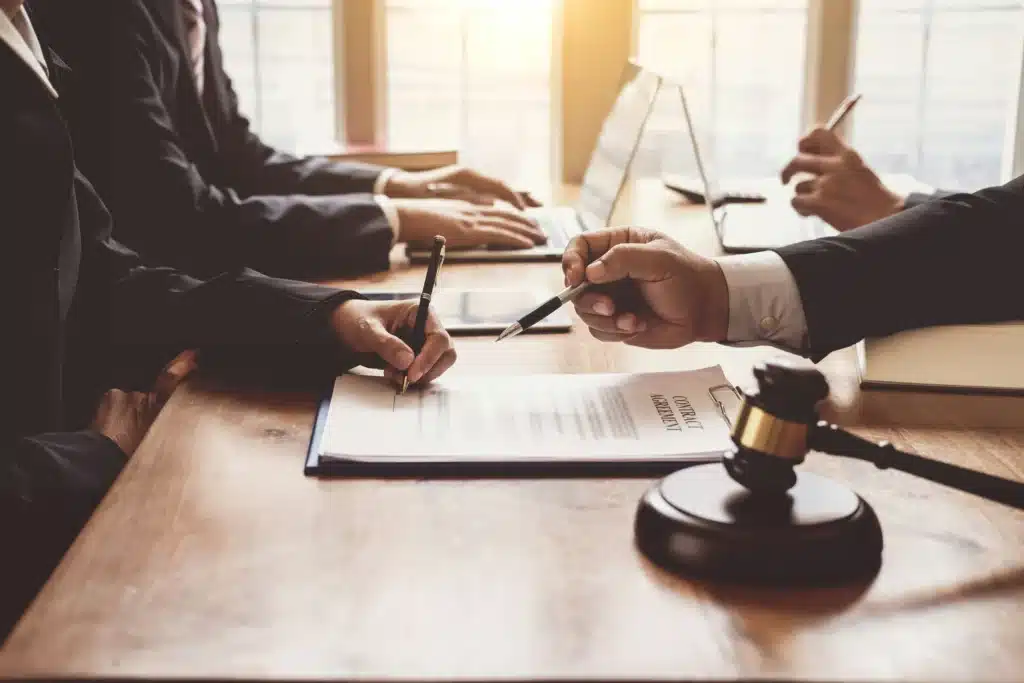 IT support pickering - A close up of a wood table with a gavel on it that shows lawyers working.