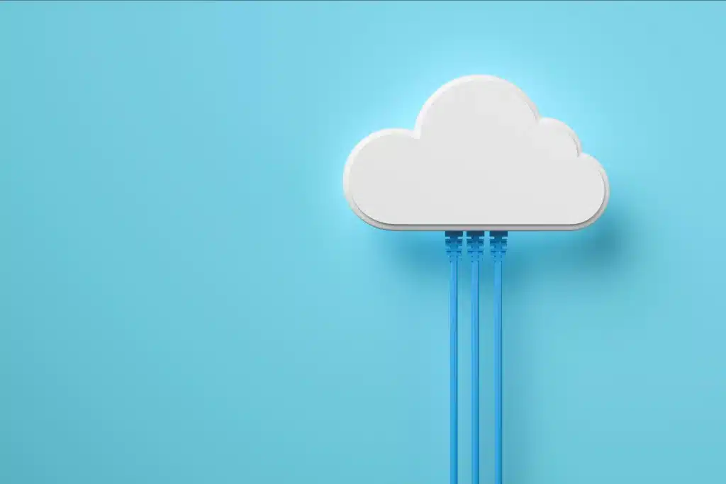 Glowing white cloud on sky blue backdrop with three blue ethernet cables plugged into bottom