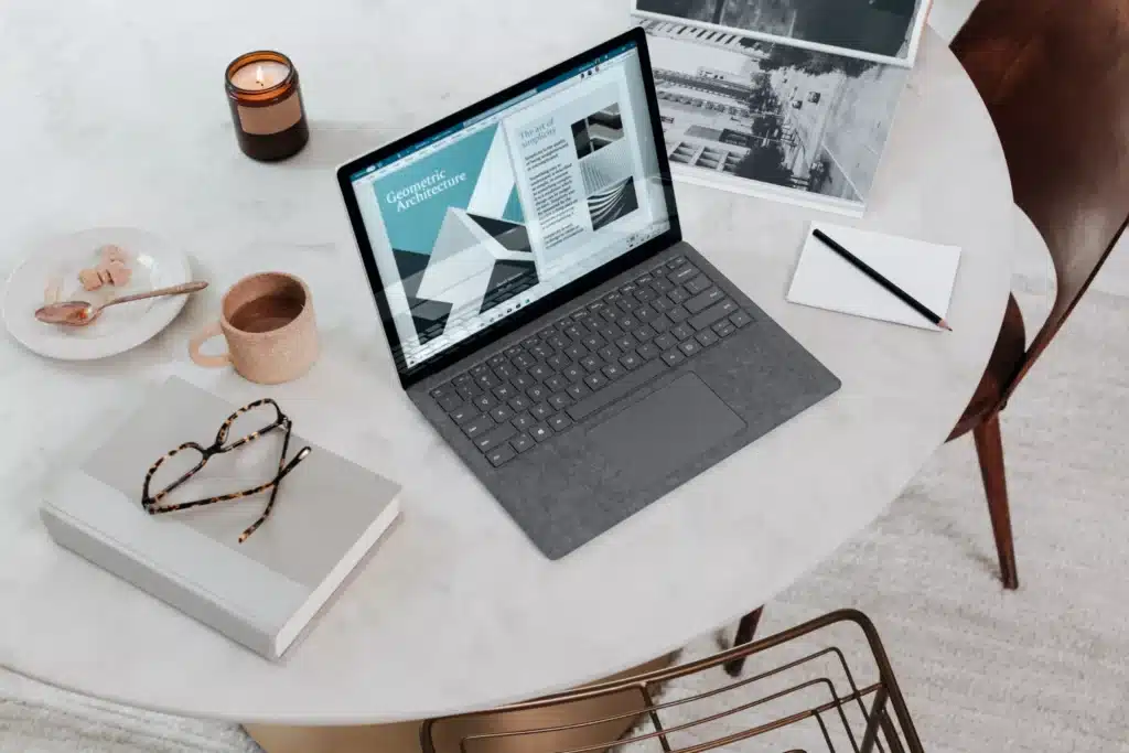 A gray laptop on a white table.