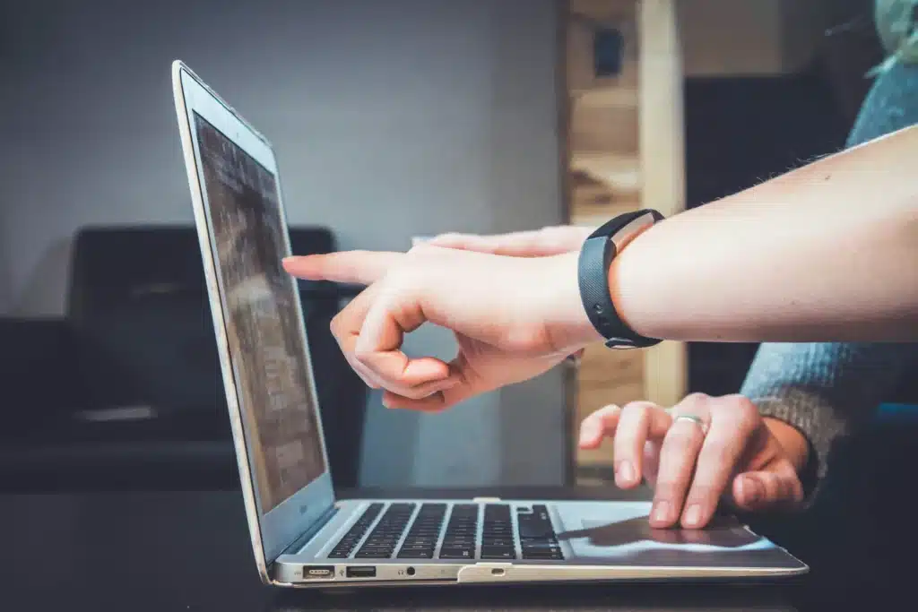 People pointing at MacBook Air