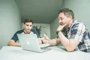 Men working on Macbook 