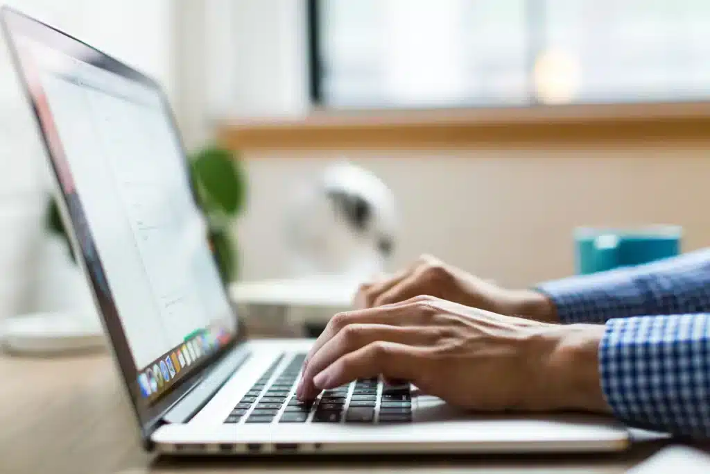 Man typing on a Mac