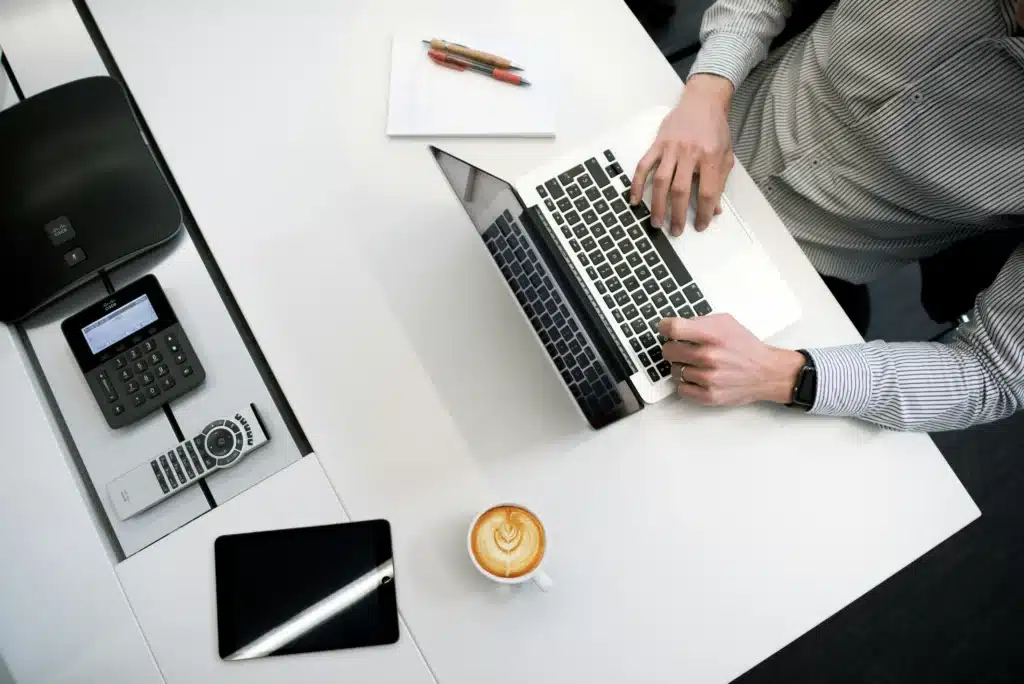 Man on Macbook at office desk