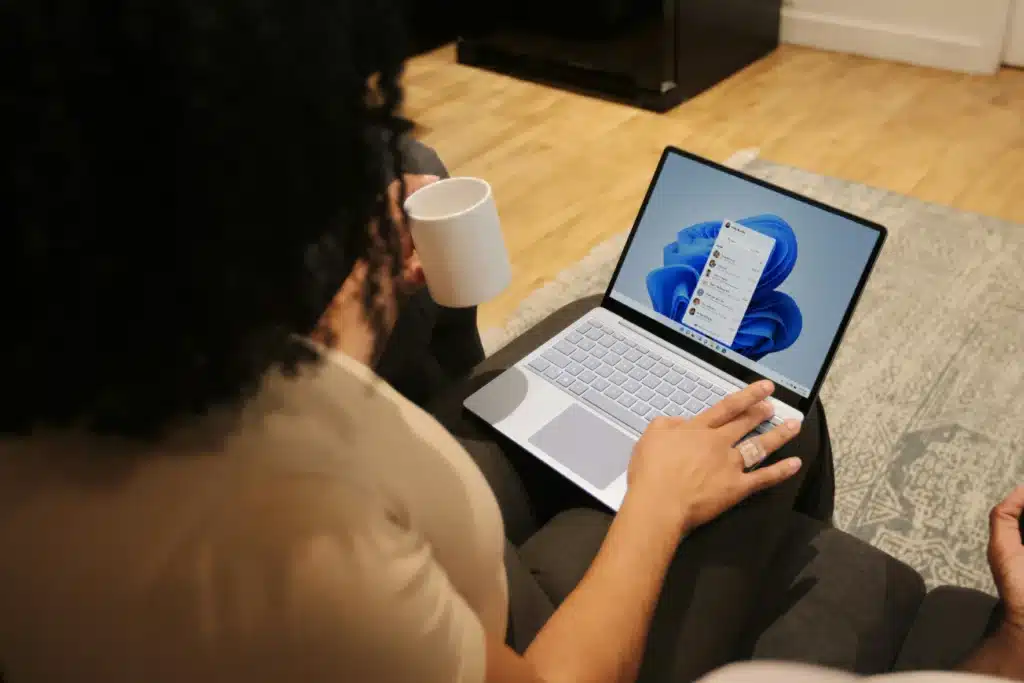 Woman using Microsoft Surface laptop on her lap