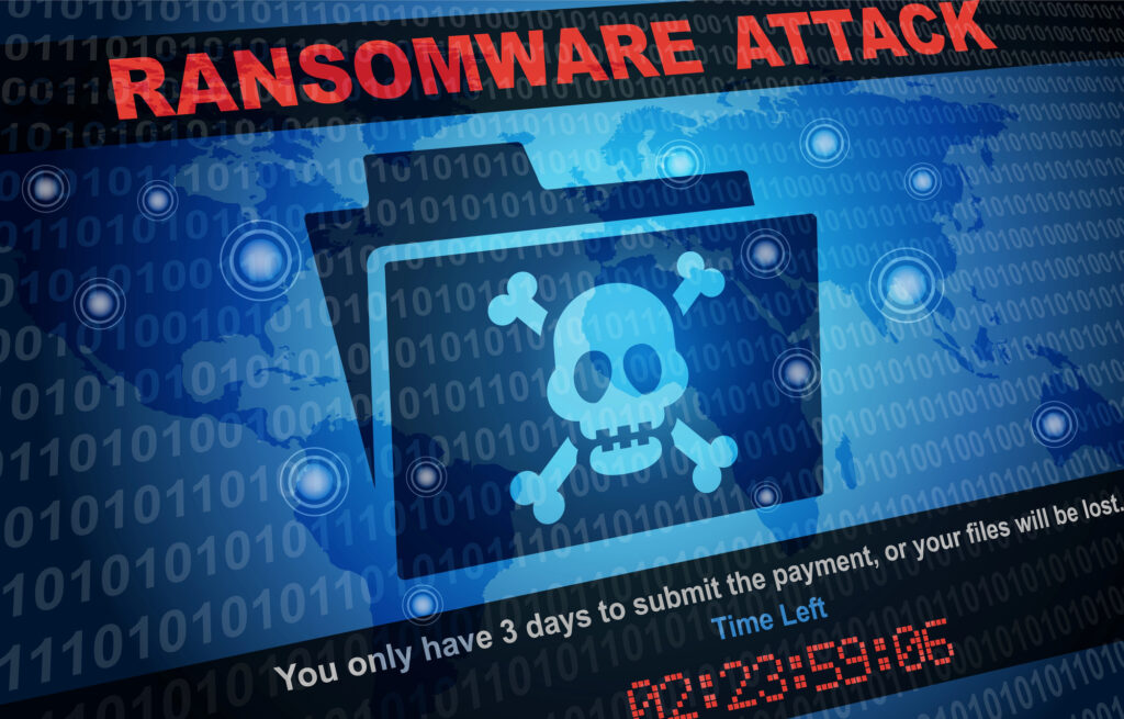 Computer screen displaying a ransomware attack warning with a skull icon, countdown timer, and encrypted file message, illustrating the impact of cyberattacks on business systems.