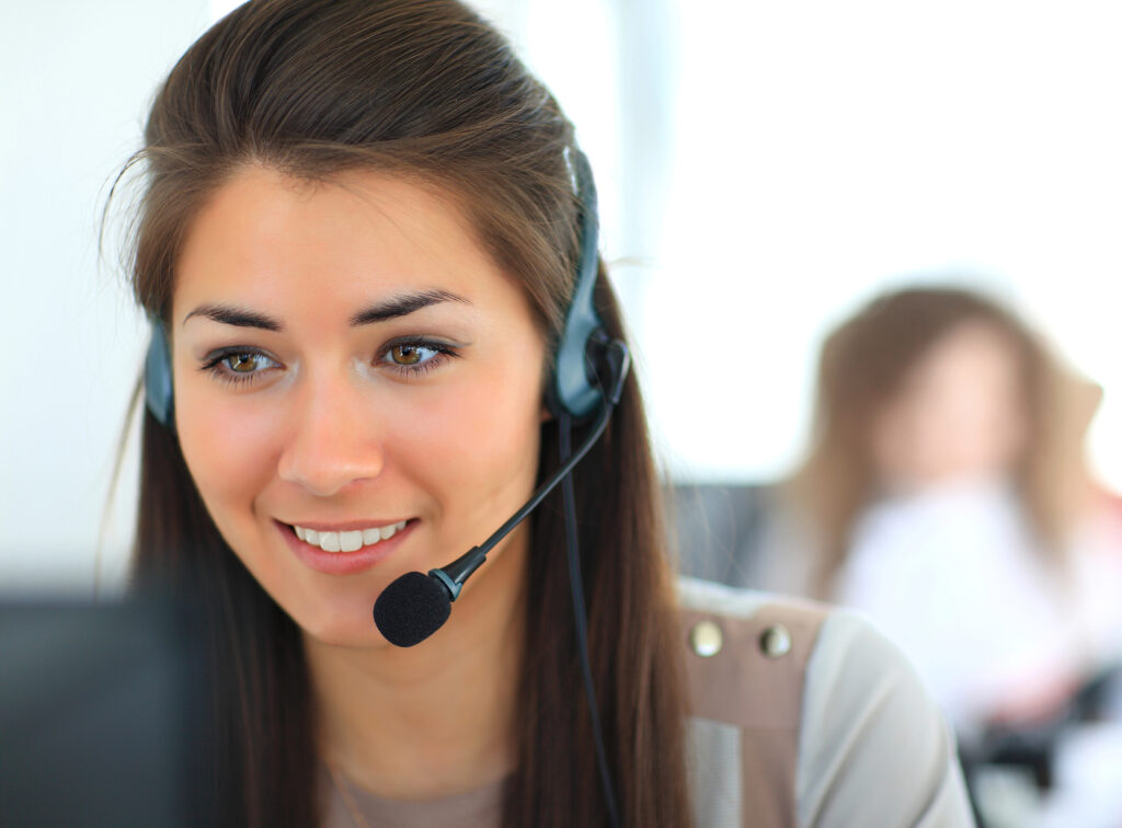 Friendly IT support specialist assisting a small business customer, highlighting clear communication and plain-English technical support.